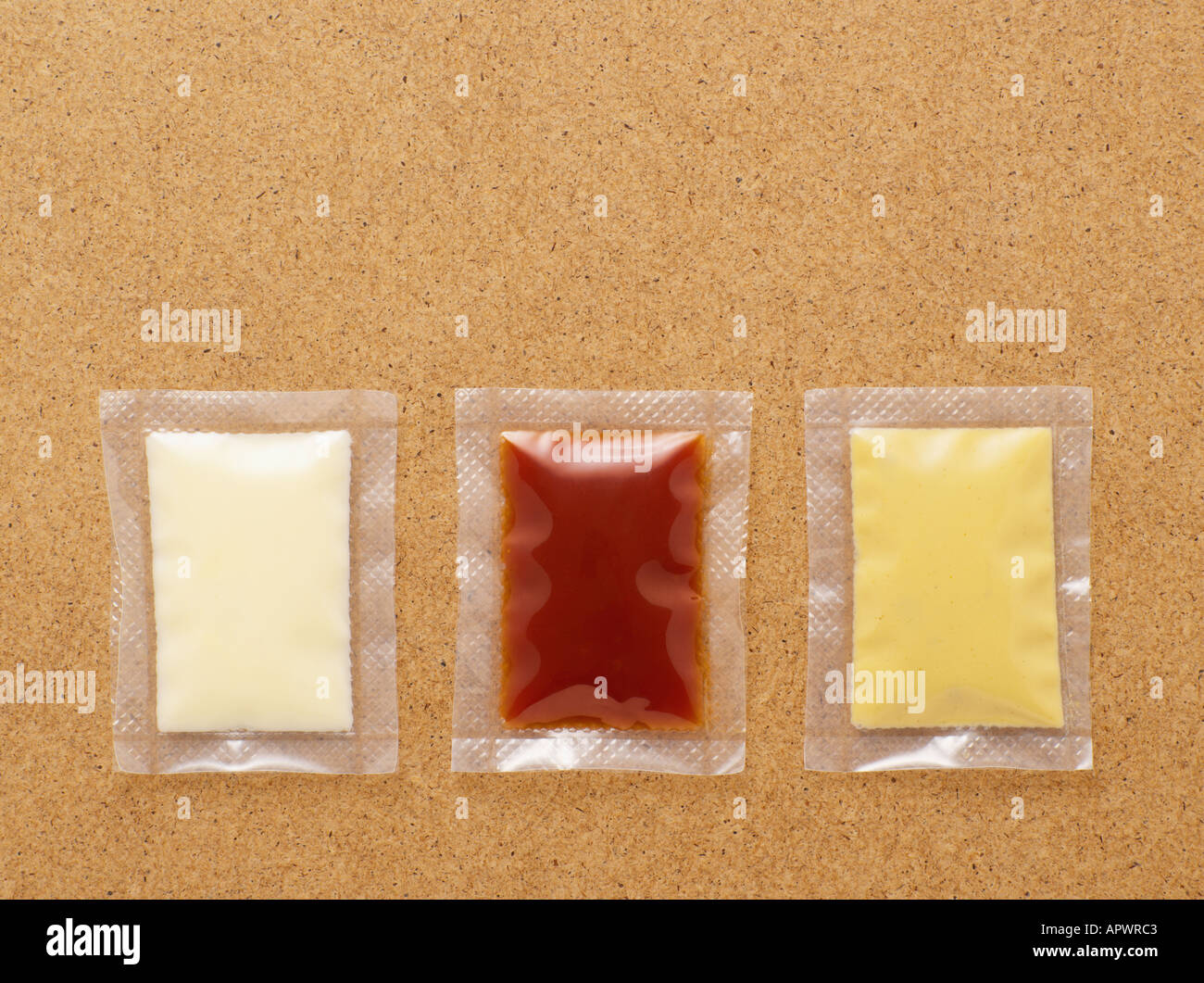 Three condiment sachets Stock Photo Alamy