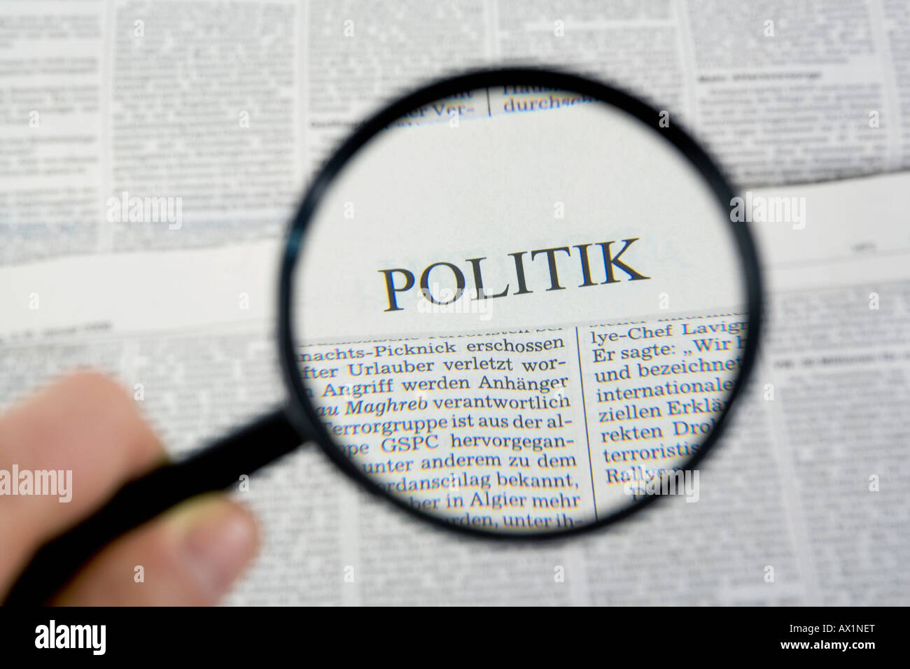 Reading the newspaper with a magnifying glass Stock Photo Alamy