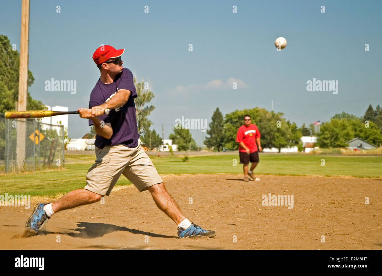 Man hitting a softball Stock Photo Alamy