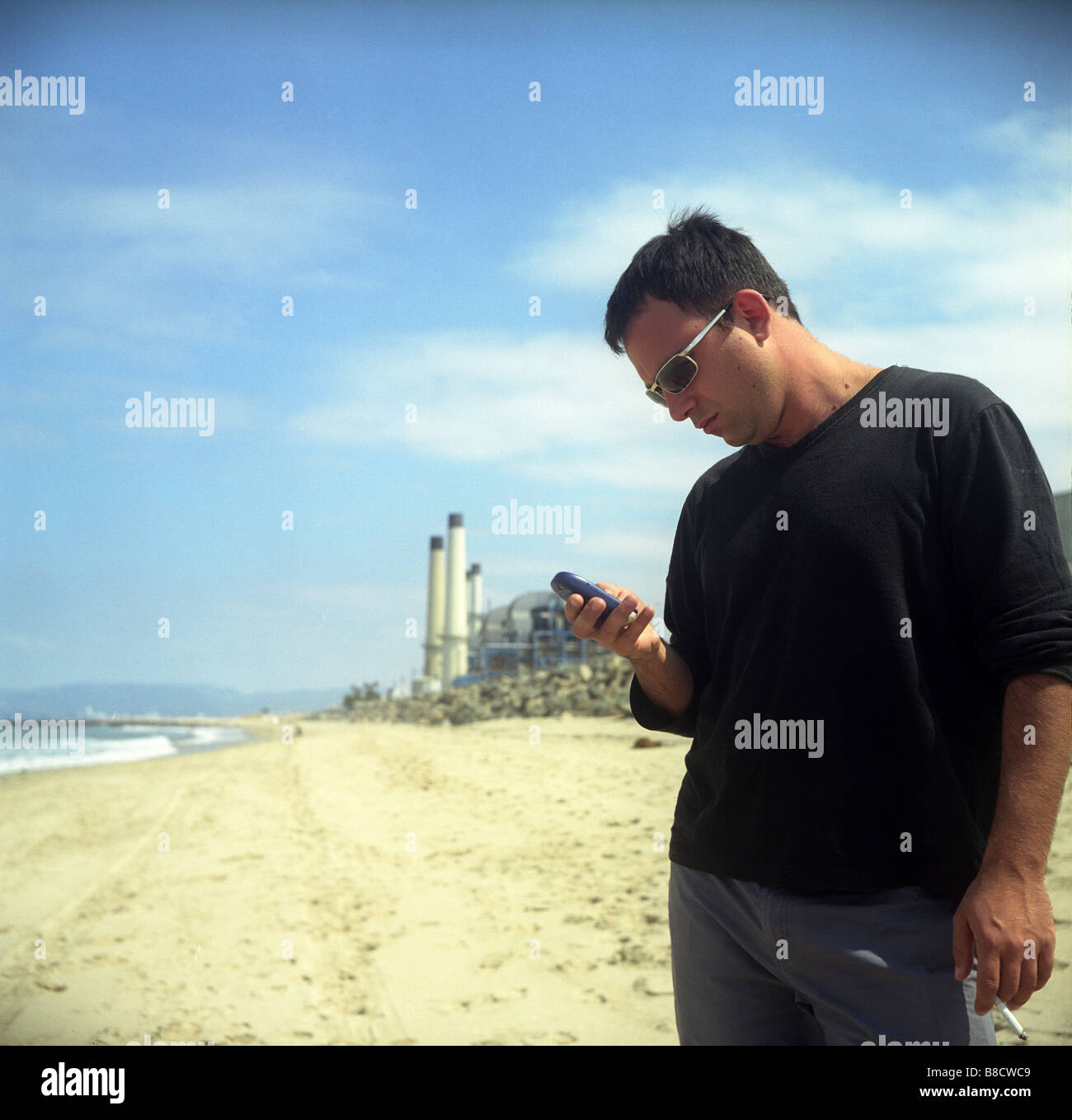 Using Cell Phone Smoking Manhattan Beach, Los Angeles Stock Photo Alamy