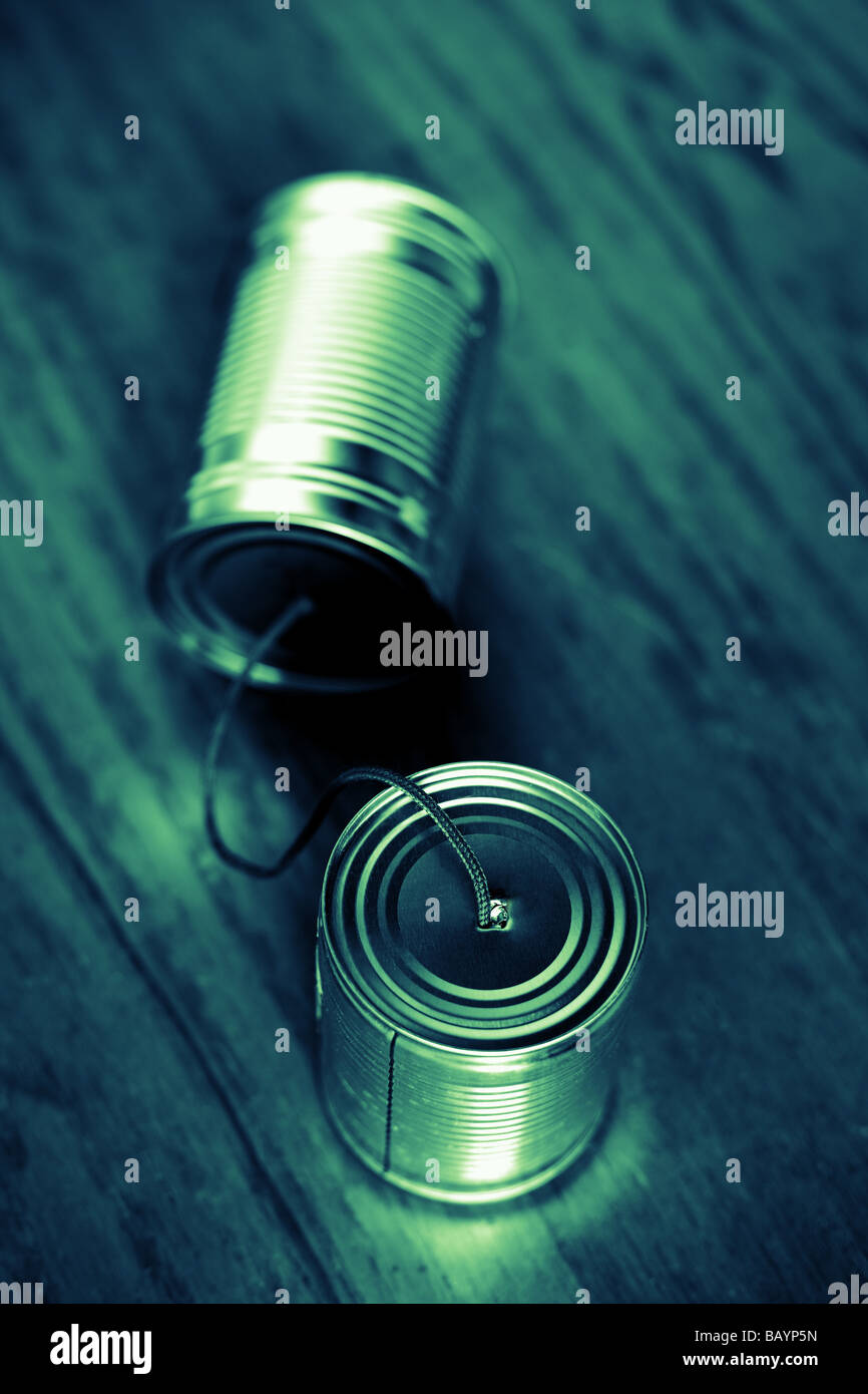 Two tin cans linked with string Stock Photo Alamy