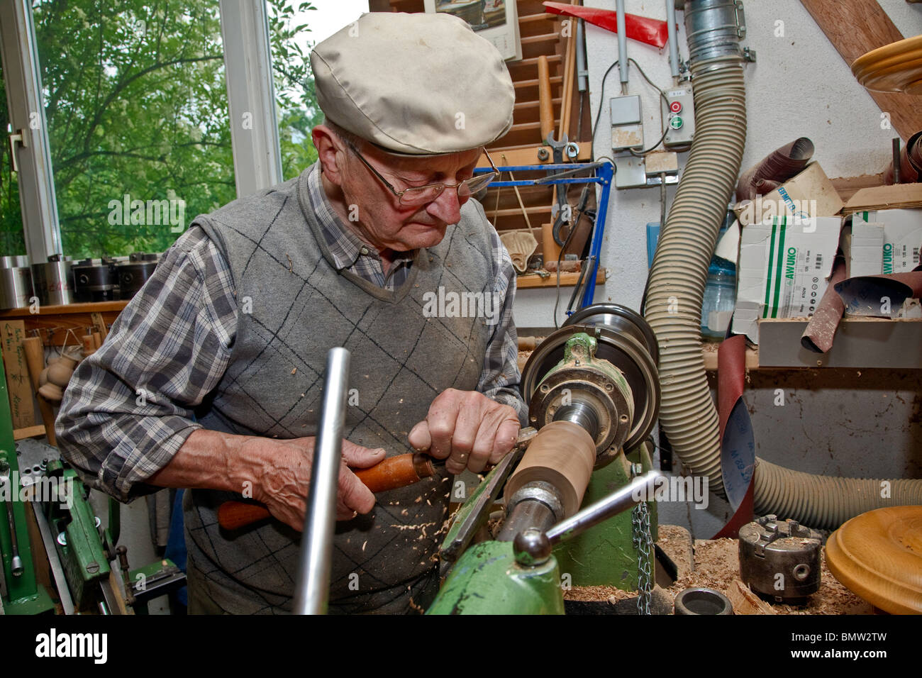 Master Woodturning man working on lathe with chisel turning and(05)