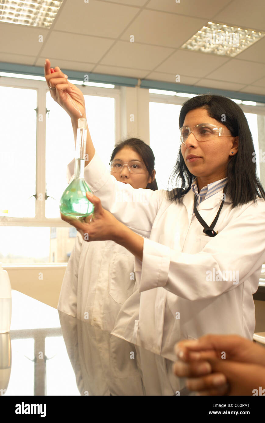 Scientist adding solution to beaker Stock Photo Alamy