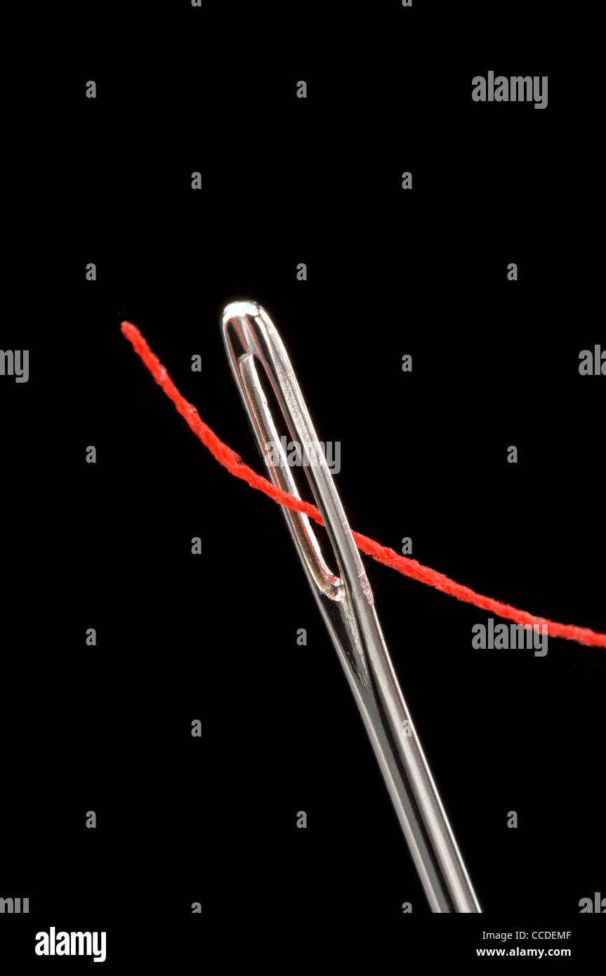 Sewing needle with red thread Stock Photo Alamy