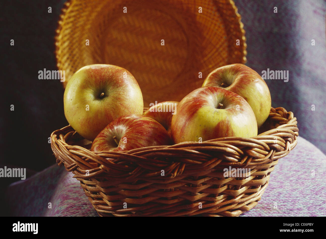 Five Apple fruit in cane basket Stock Photo Alamy