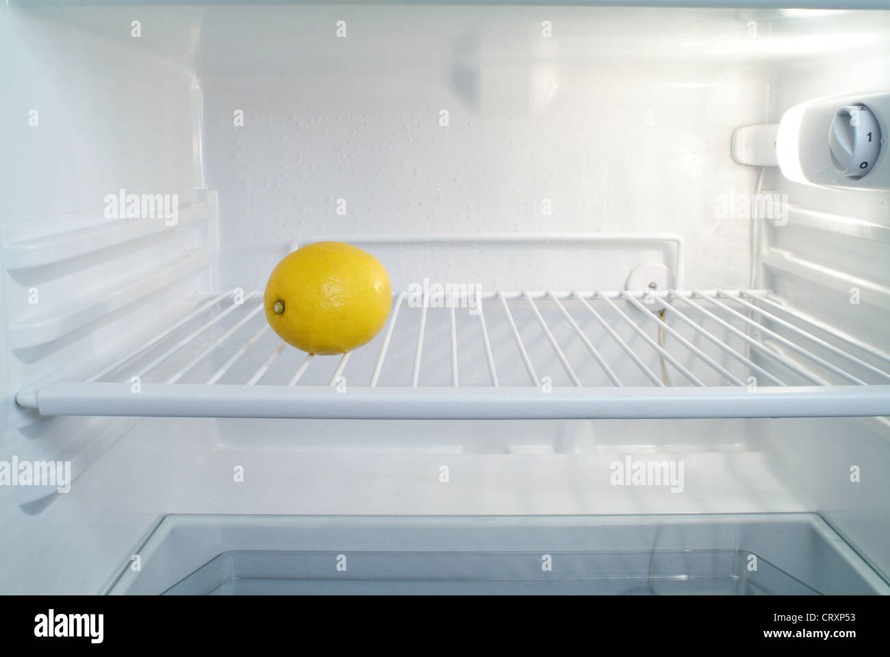 almost empty fridge with a lemon Stock Photo, Royalty Free Image