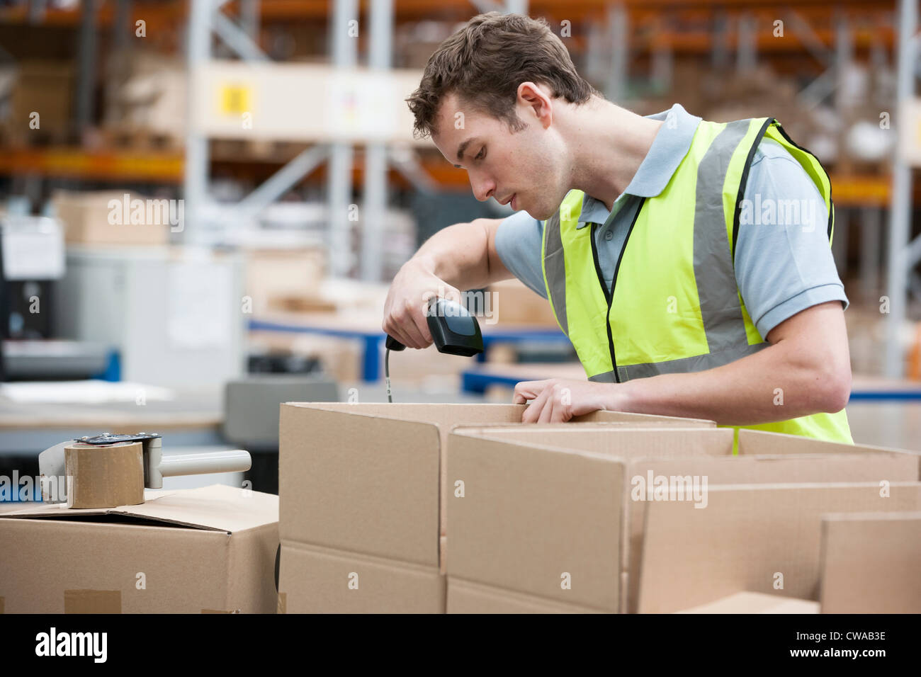 Man using barcode reader in warehouse Stock Photo Alamy