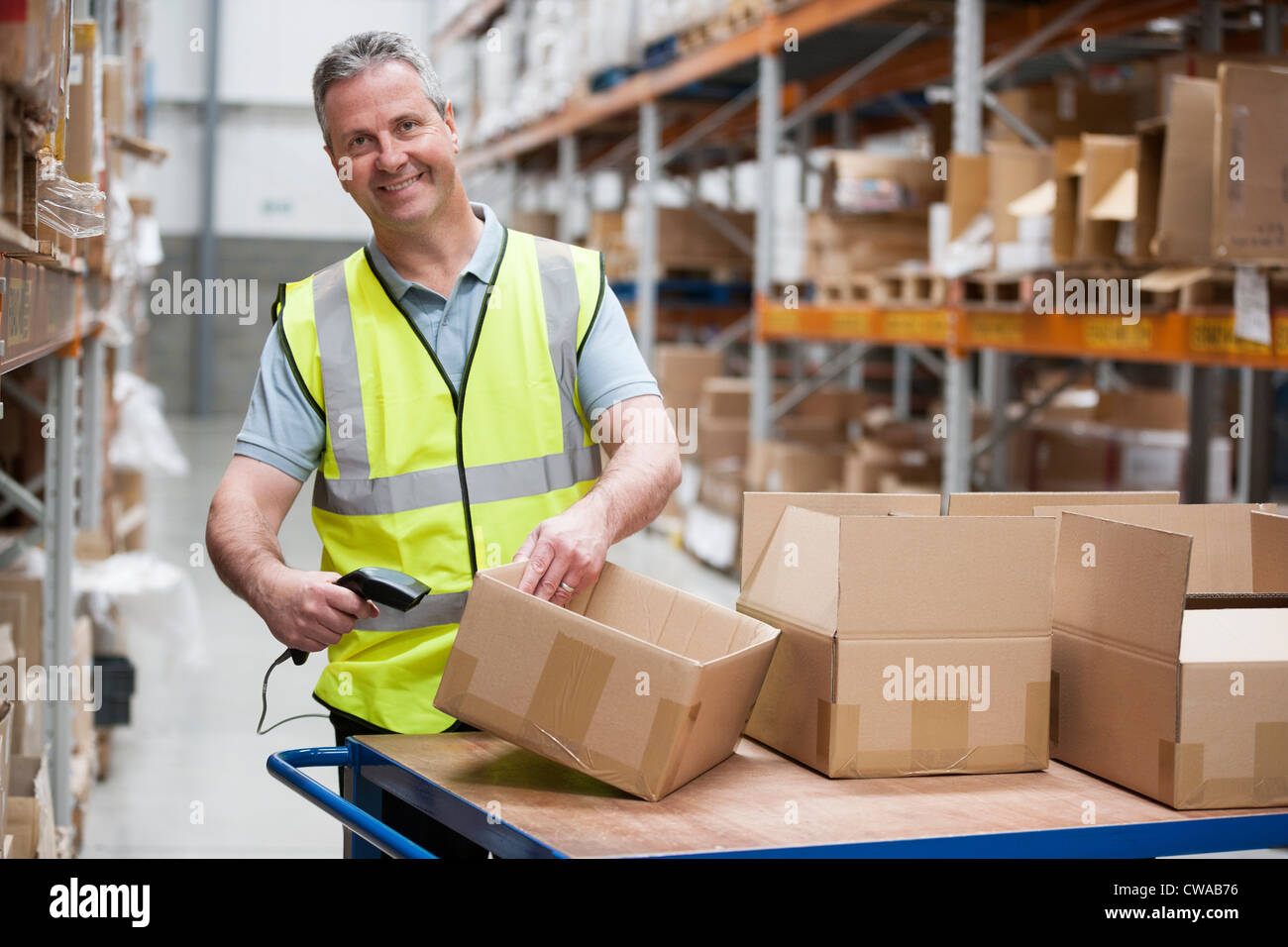 Man using barcode reader in warehouse Stock Photo Alamy