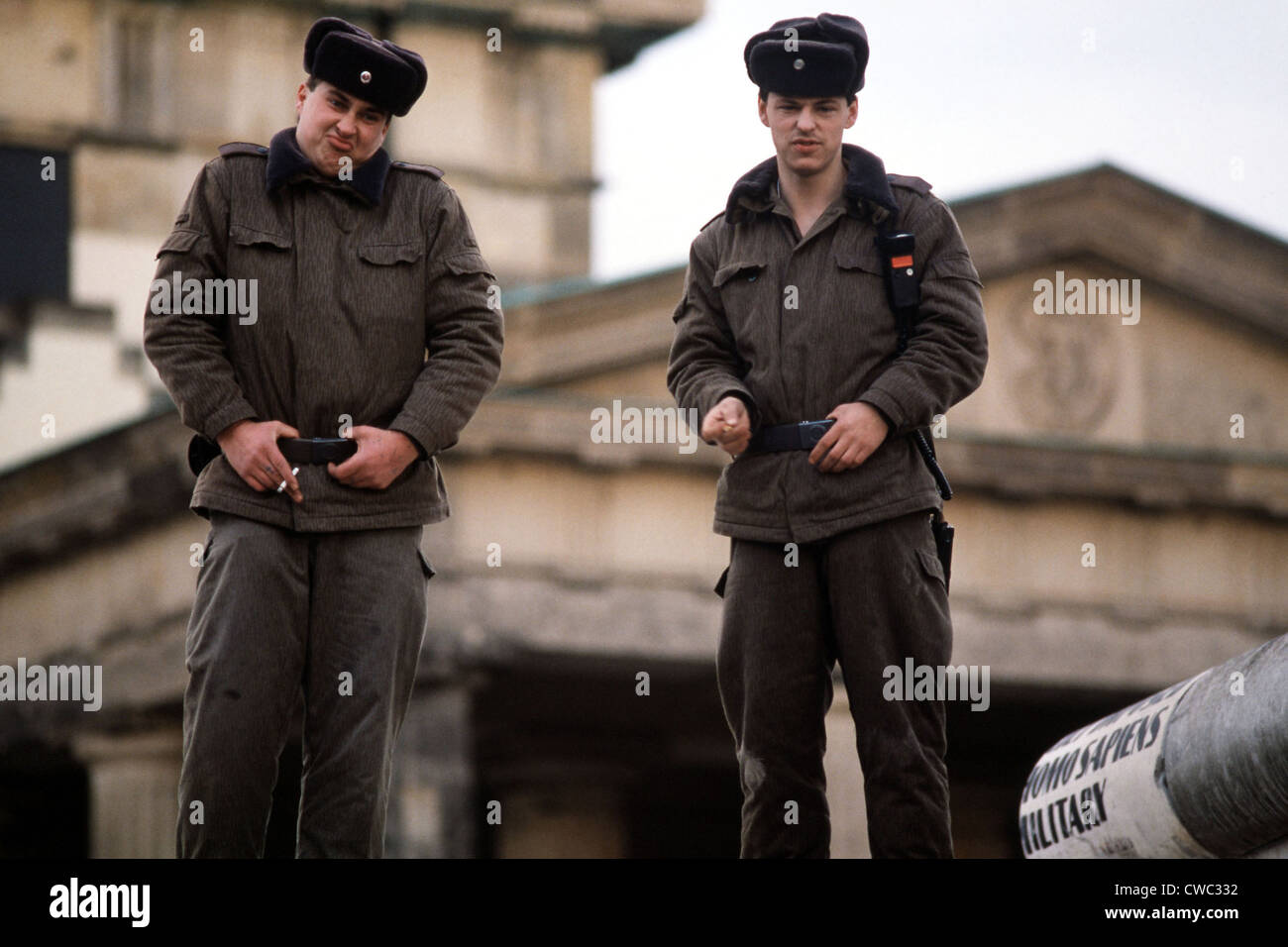 East German guards at ease atop the Berlin Wall at the Brandenburg Gate