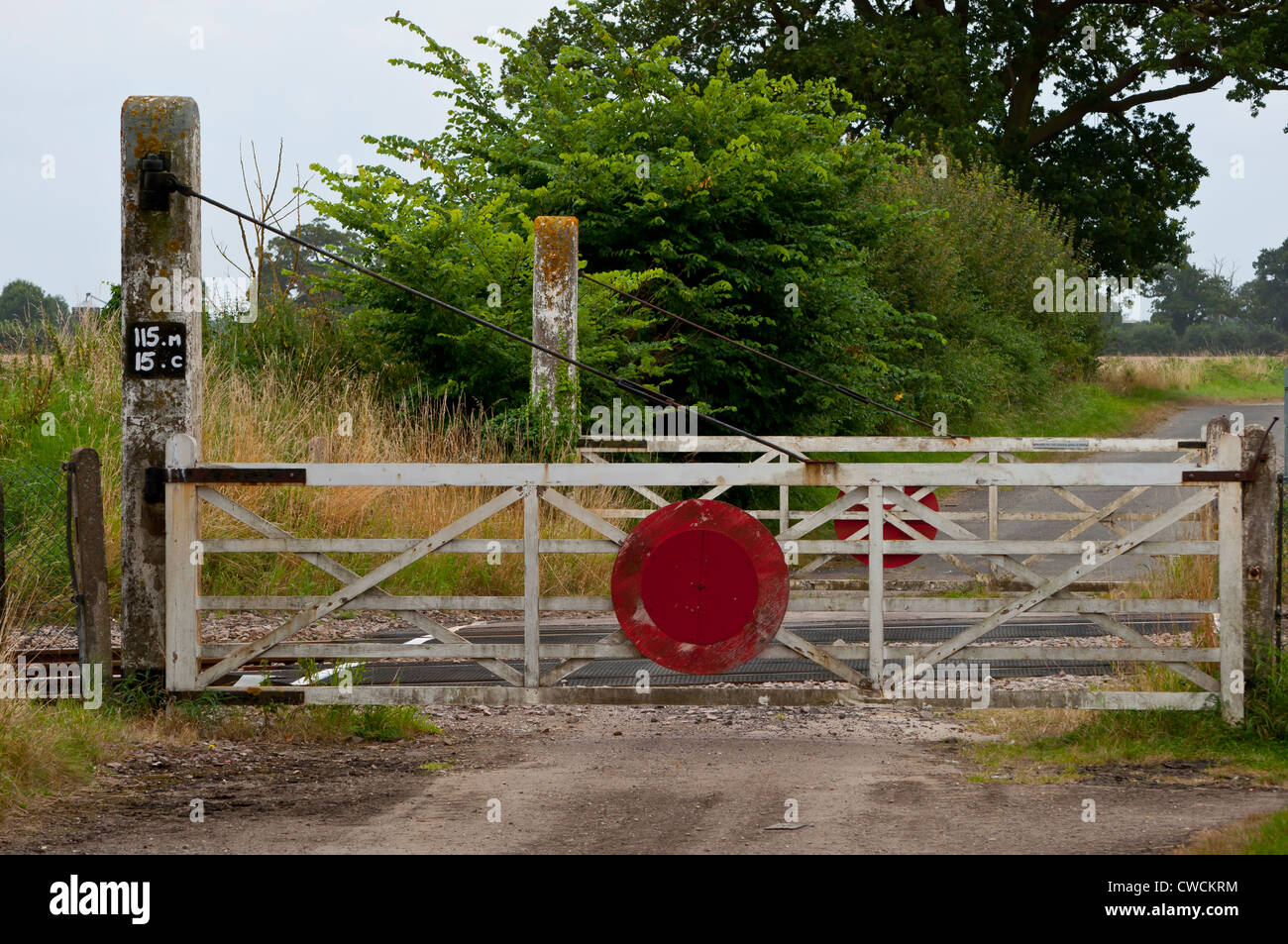 unmanned level crossing gates on country lane Stock Photo Alamy
