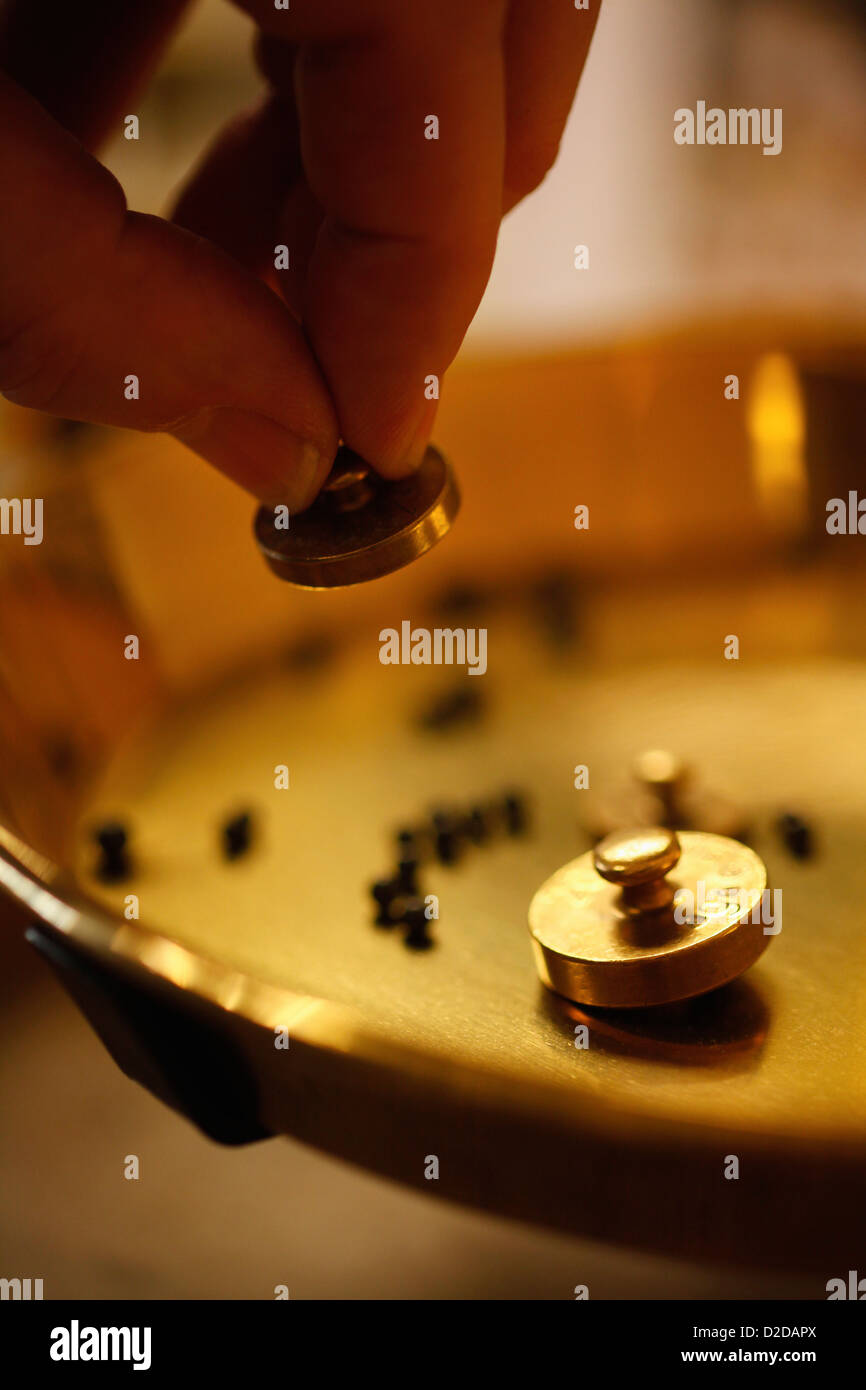A perfumer using small weights at perfumery Stock Photo Alamy