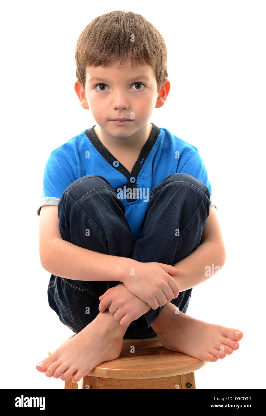 Boy sitting on a stool Stock Photo Alamy