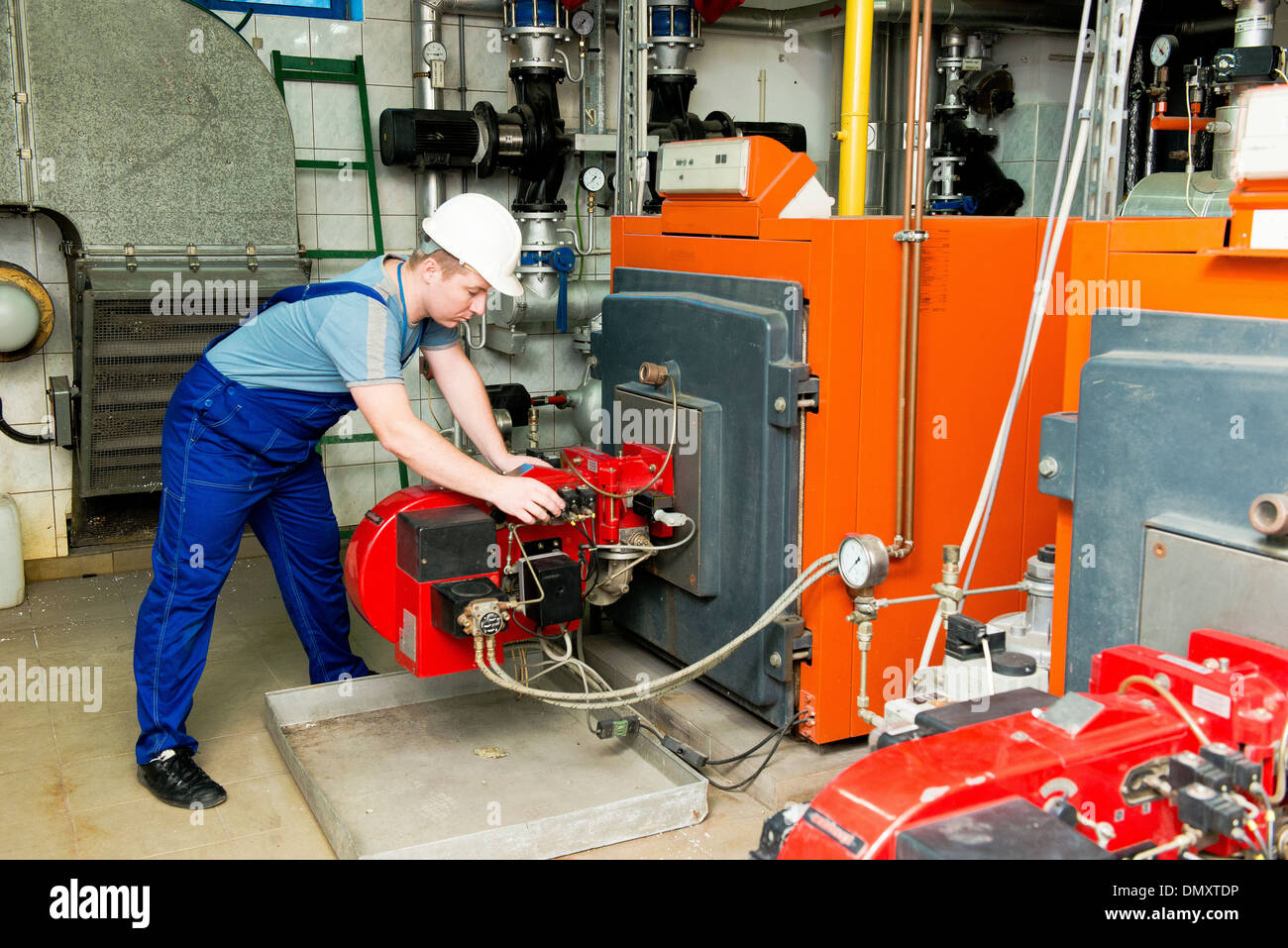 specialist checks the central heating system Stock Photo Alamy