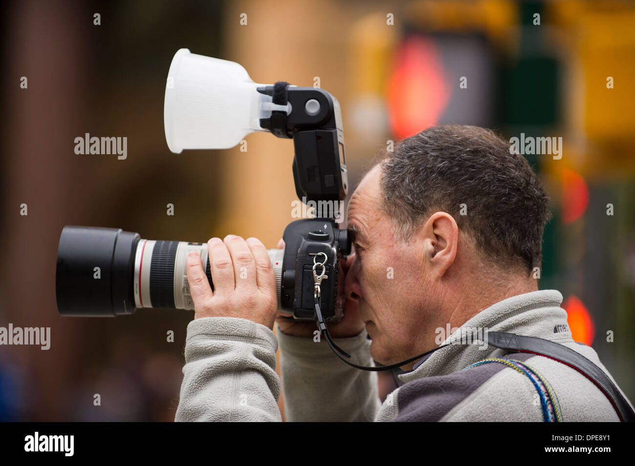 Man taking a photograph with a diffuser on the flash Stock Photo Alamy