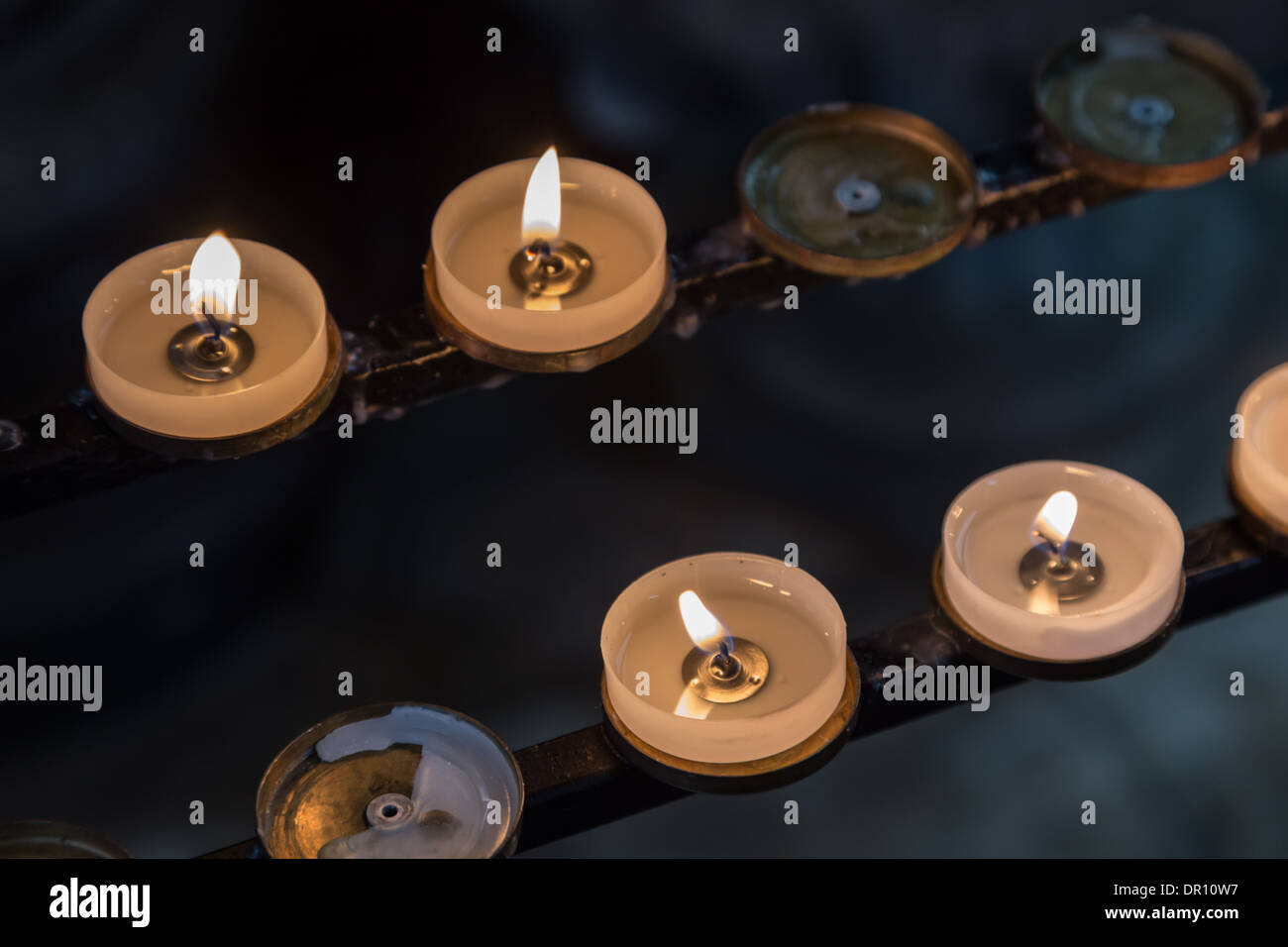 Church candles on iron rack Stock Photo Alamy