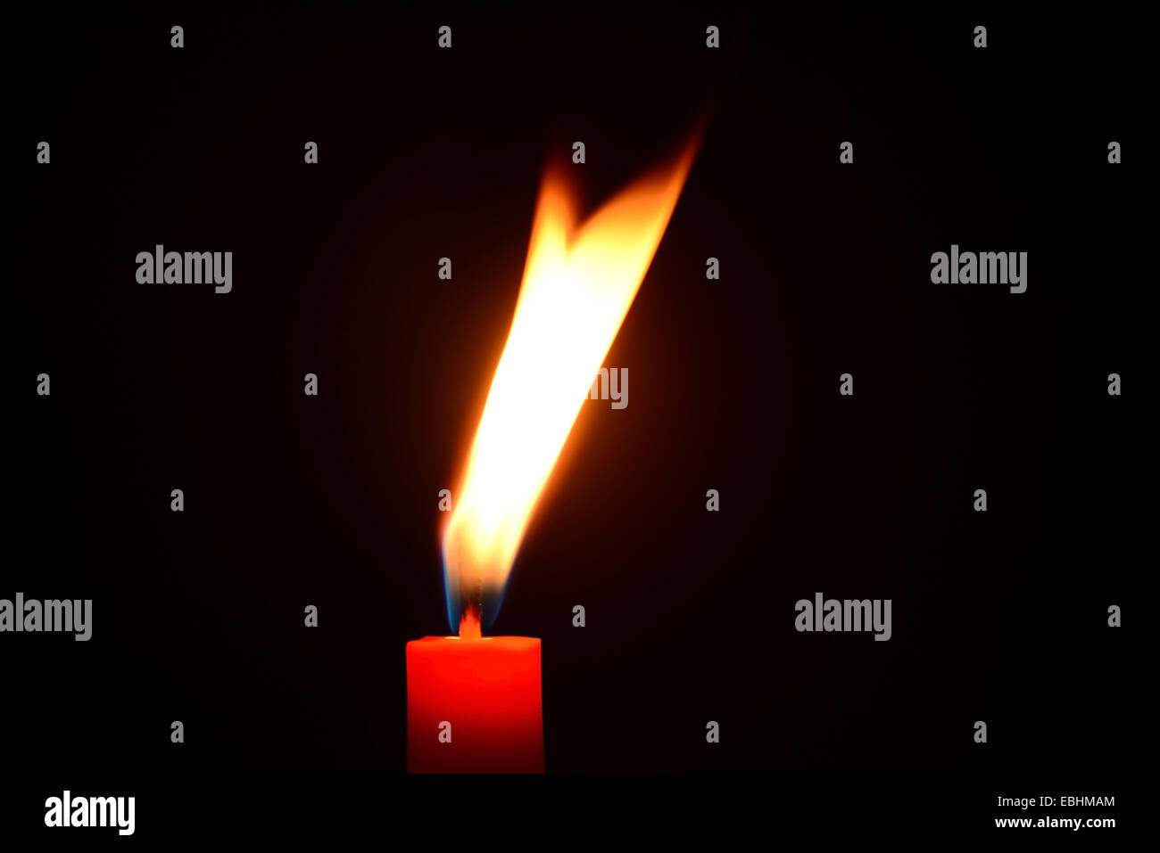 Red candle burning on a black background Stock Photo Alamy