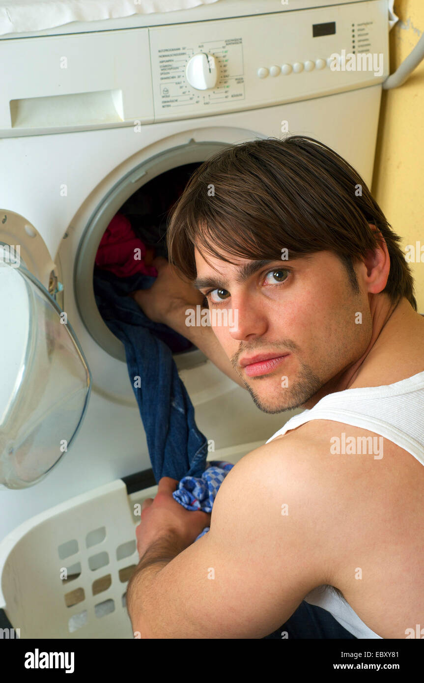 man using a washing machine Stock Photo Alamy