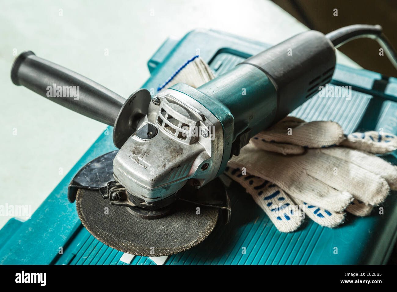 Grinding machine with protective gloves Stock Photo Alamy