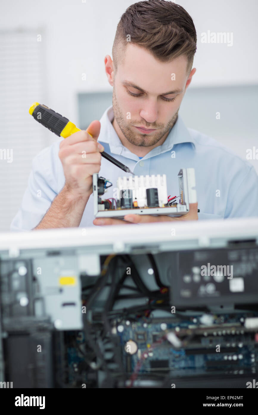 Computer engineer working on cpu part in front of open cpu Stock Photo