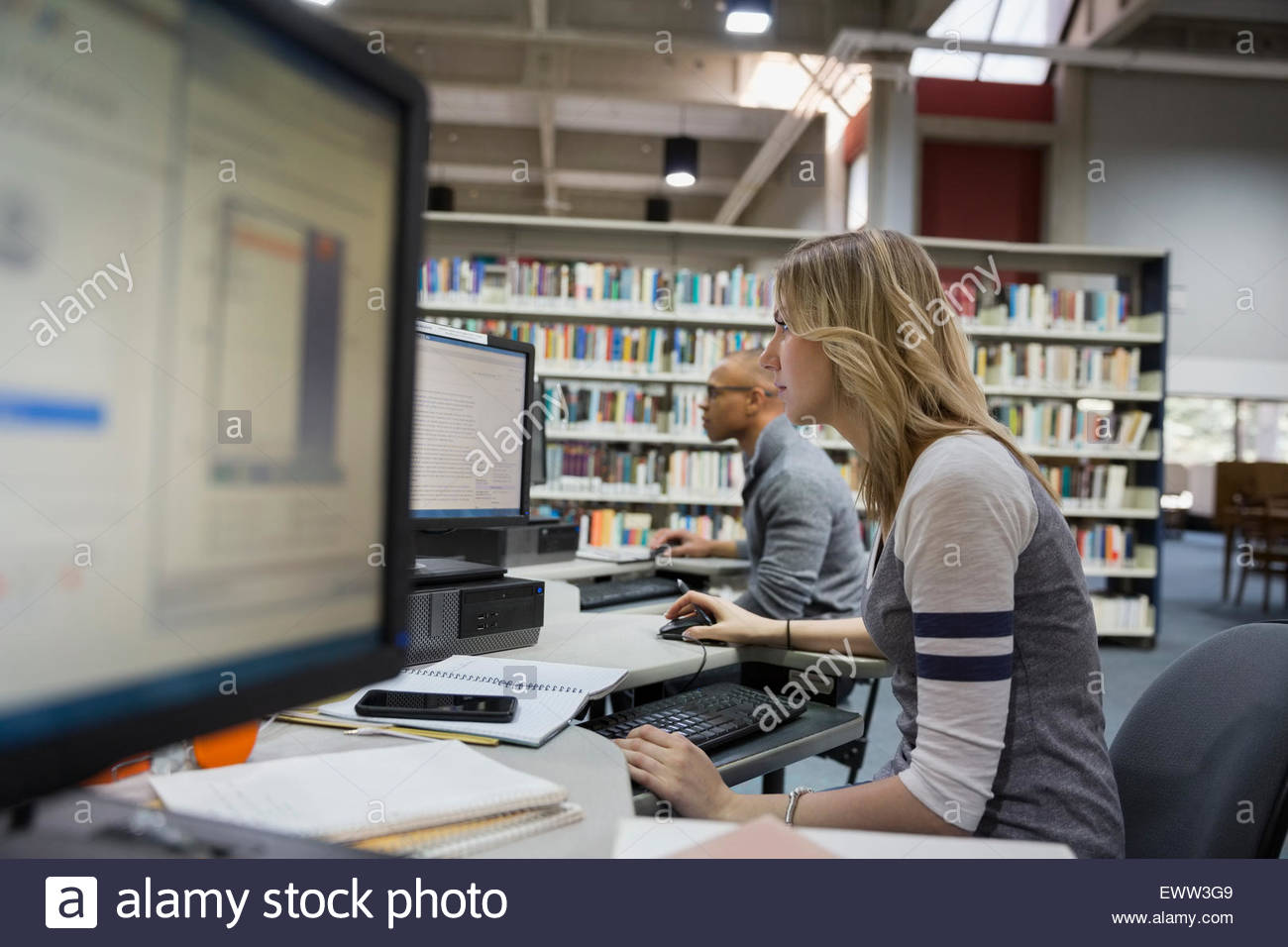 College students using computers in library Stock Photo Alamy