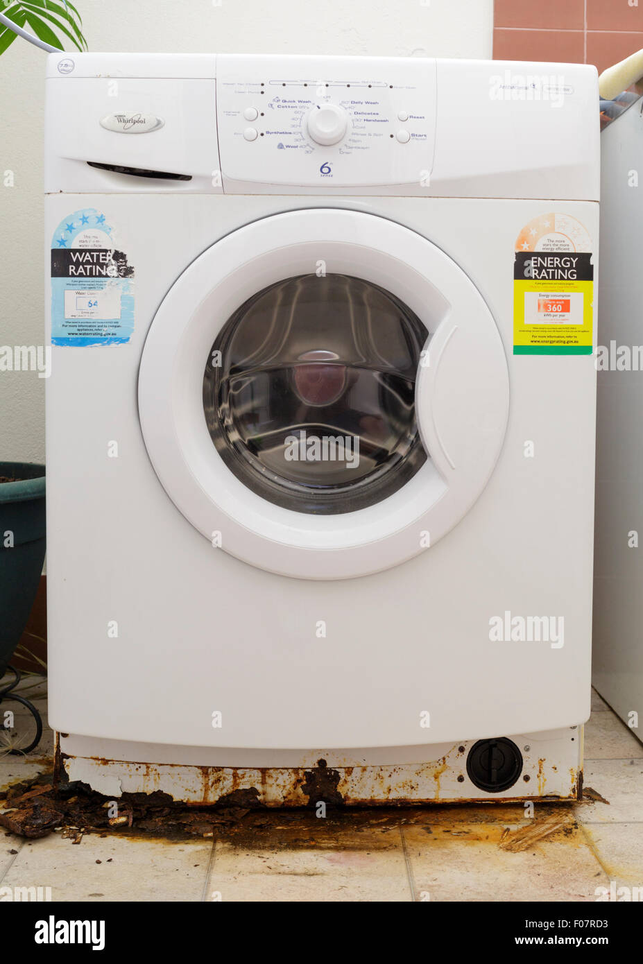 A leaking washing machine with large patches of rust at the base Stock