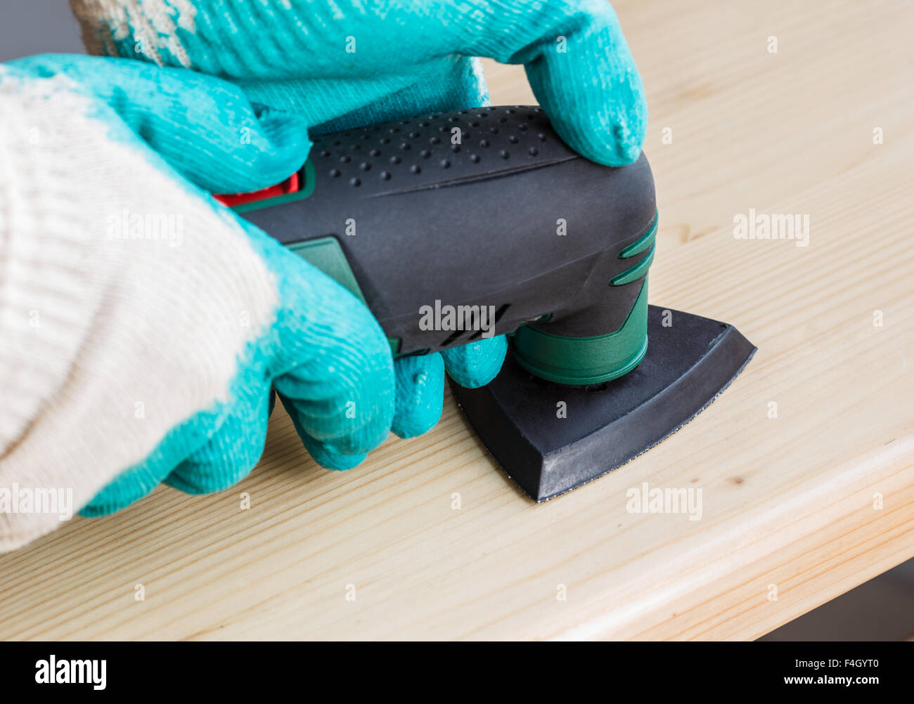 Worker using electric grinder machine Stock Photo Alamy