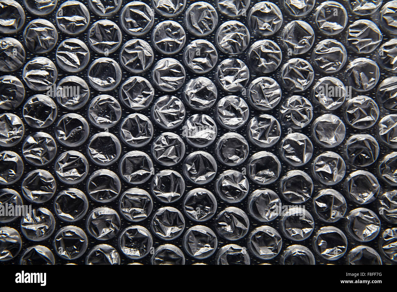Bubble wrap, black background Stock Photo Alamy