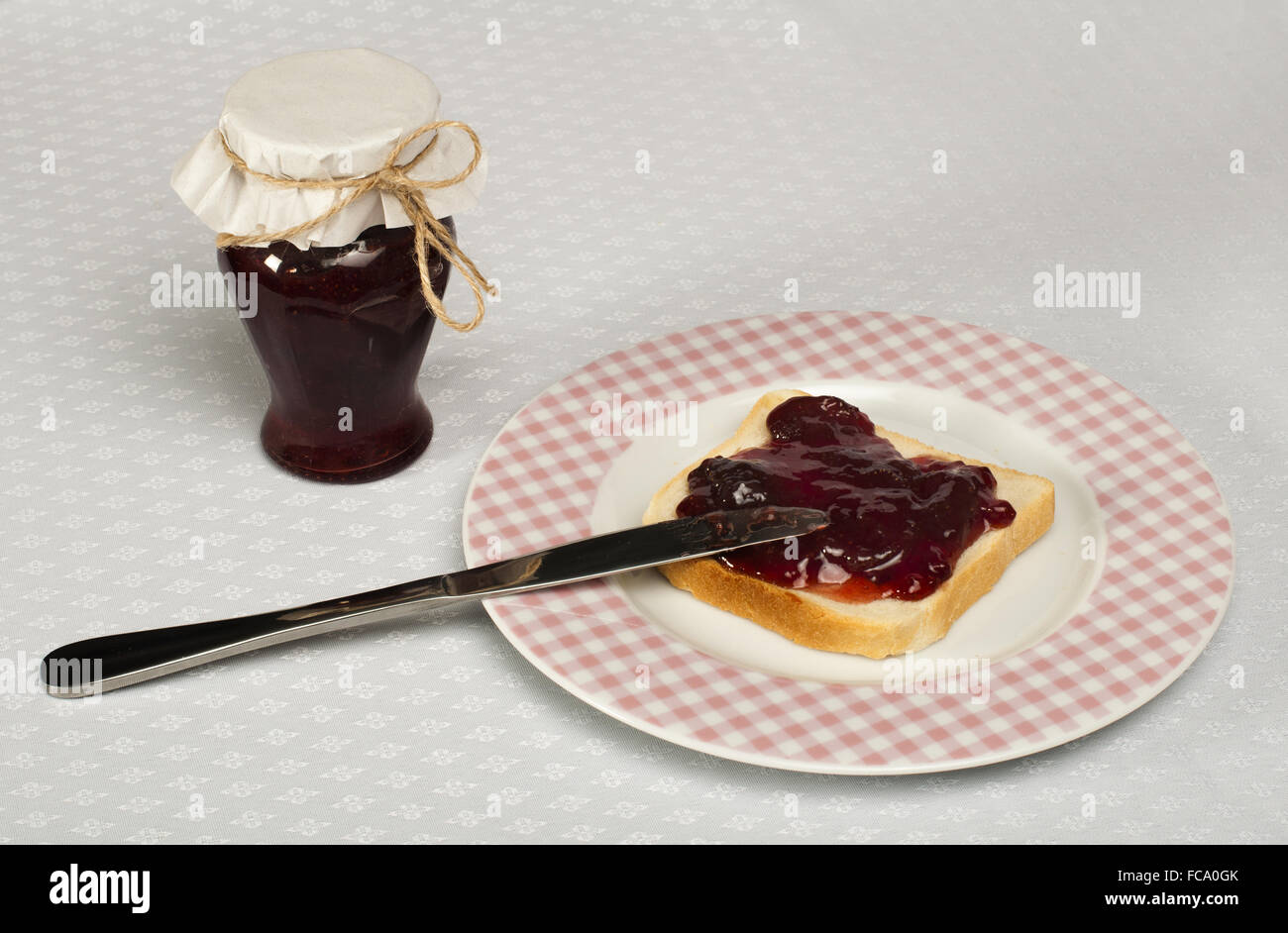 Spread jam on bread Stock Photo Alamy