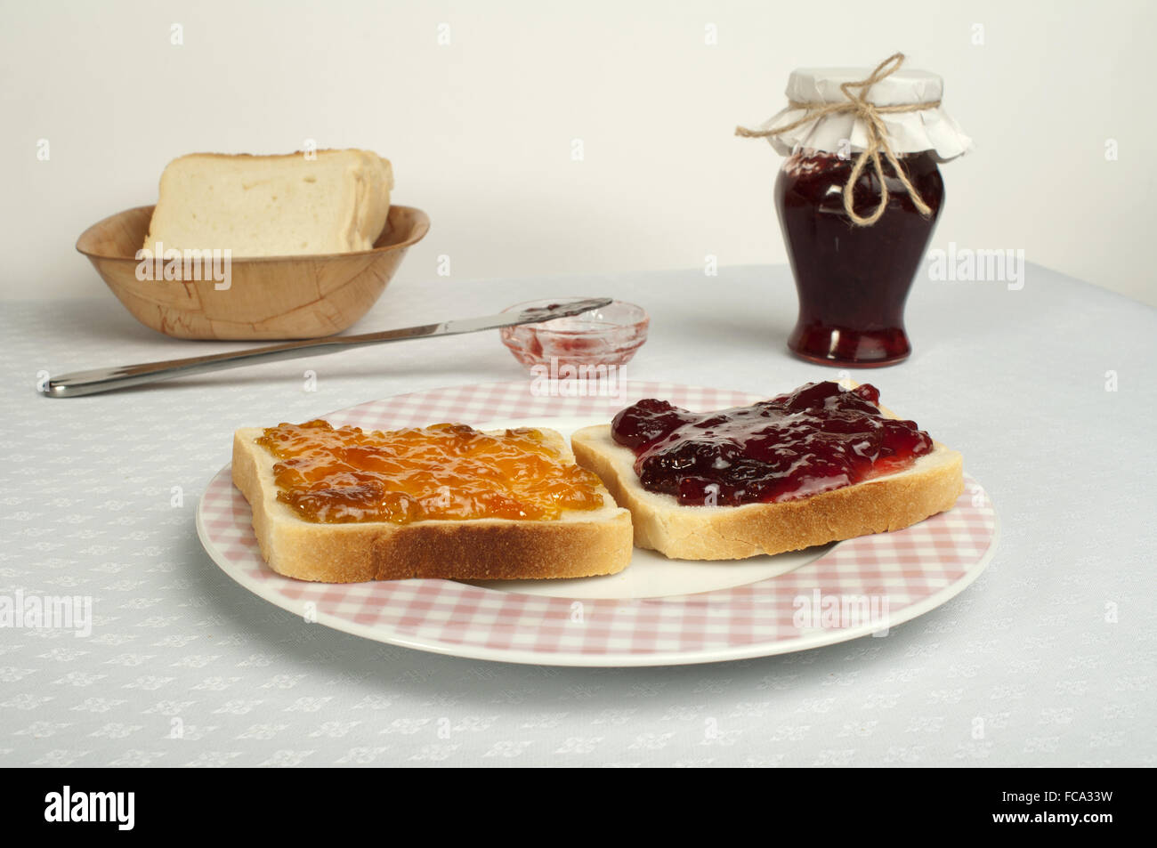 Spread jam on bread Stock Photo Alamy