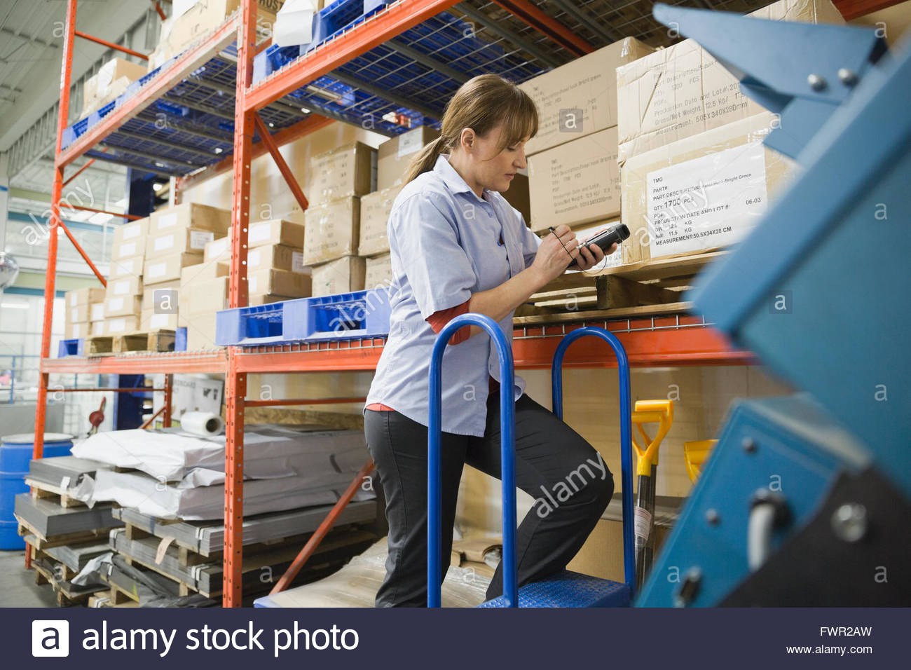 Worker using bar code reader in warehouse Stock Photo Alamy