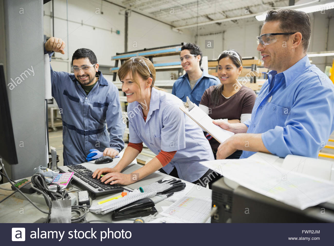Workers using computer in manufacturing plant Stock Photo Alamy
