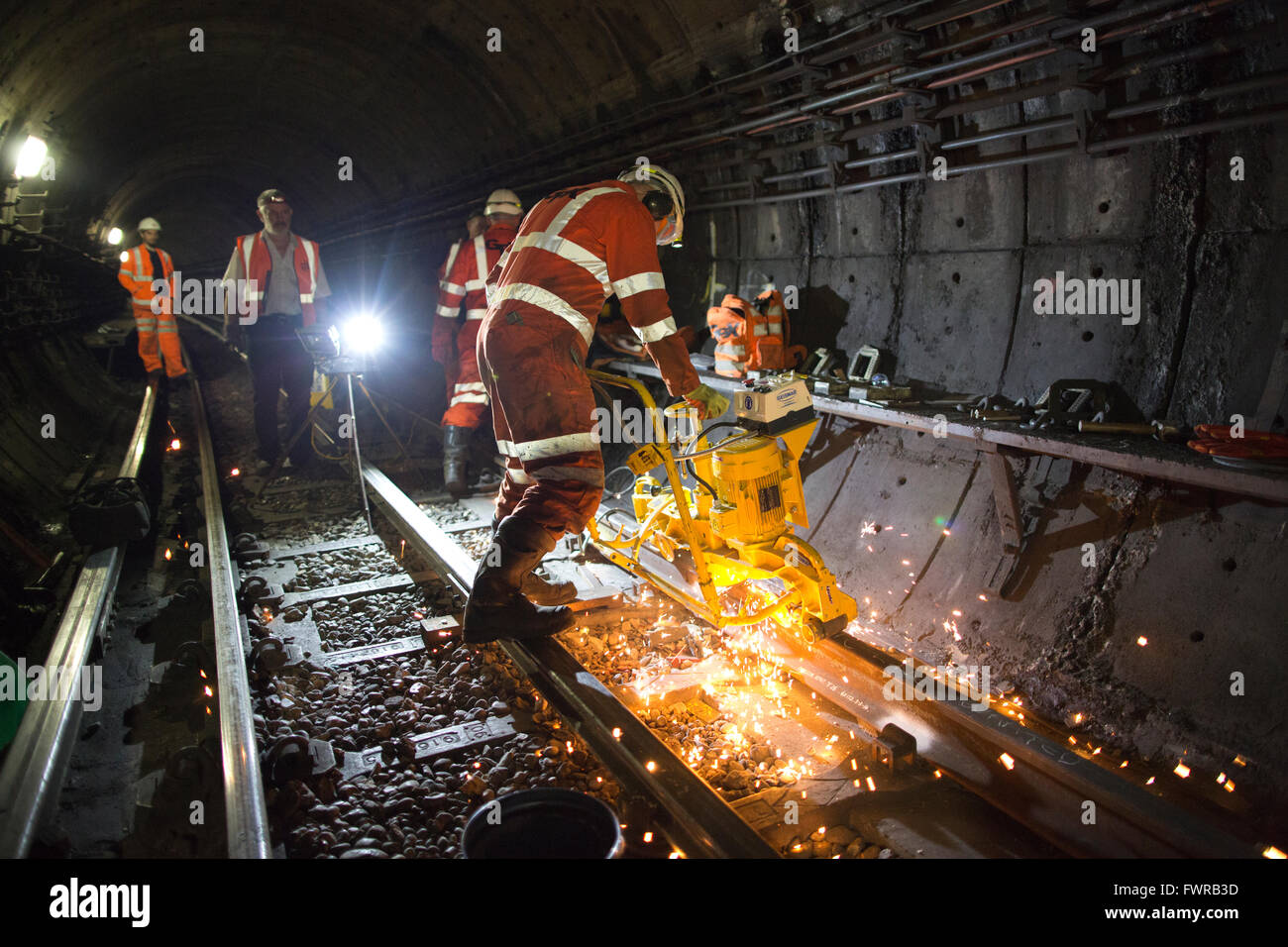 Engineers grinding replacement track components after using thermite
