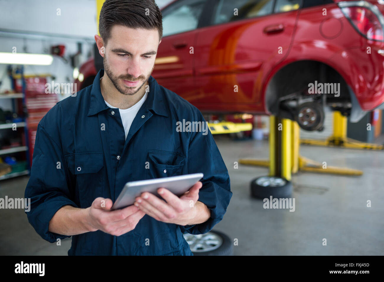 Mechanic using digital tablet Stock Photo Alamy