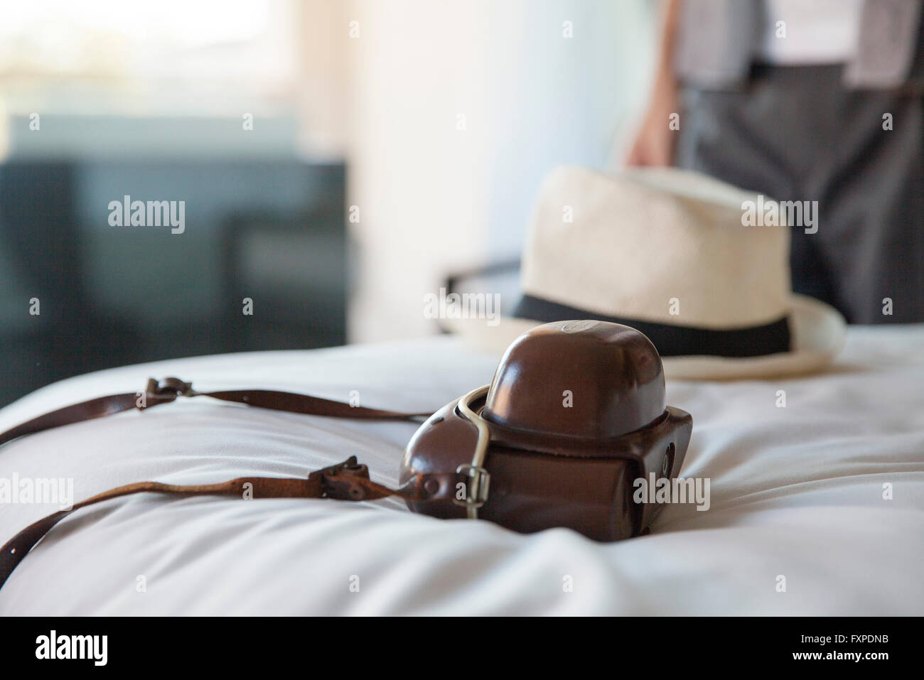 Camera and hat on bed Stock Photo Alamy