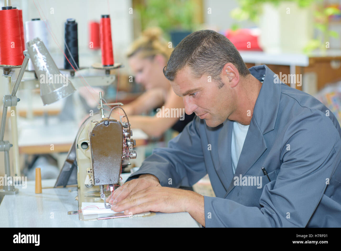 Man using sewing machine Stock Photo Alamy
