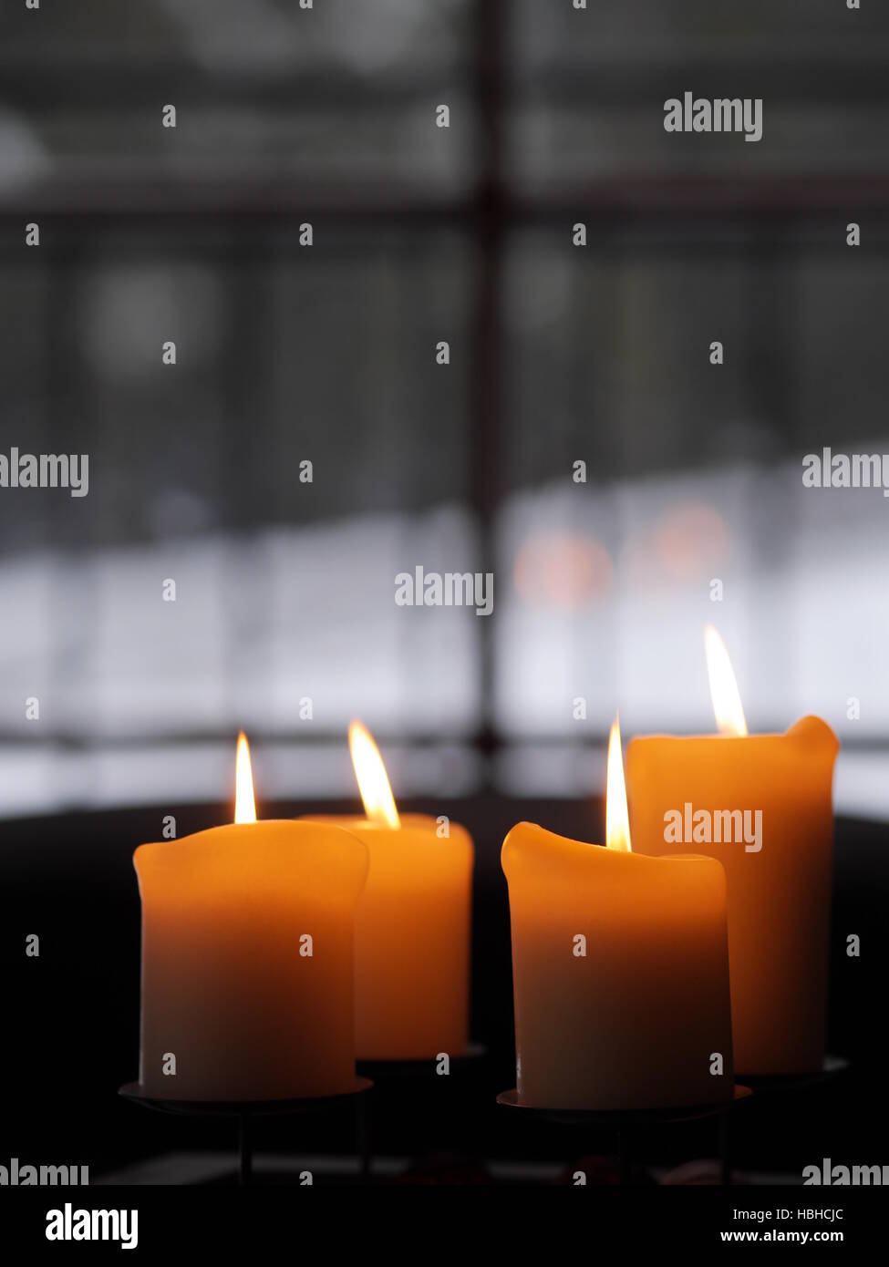 Four candles burning Stock Photo Alamy