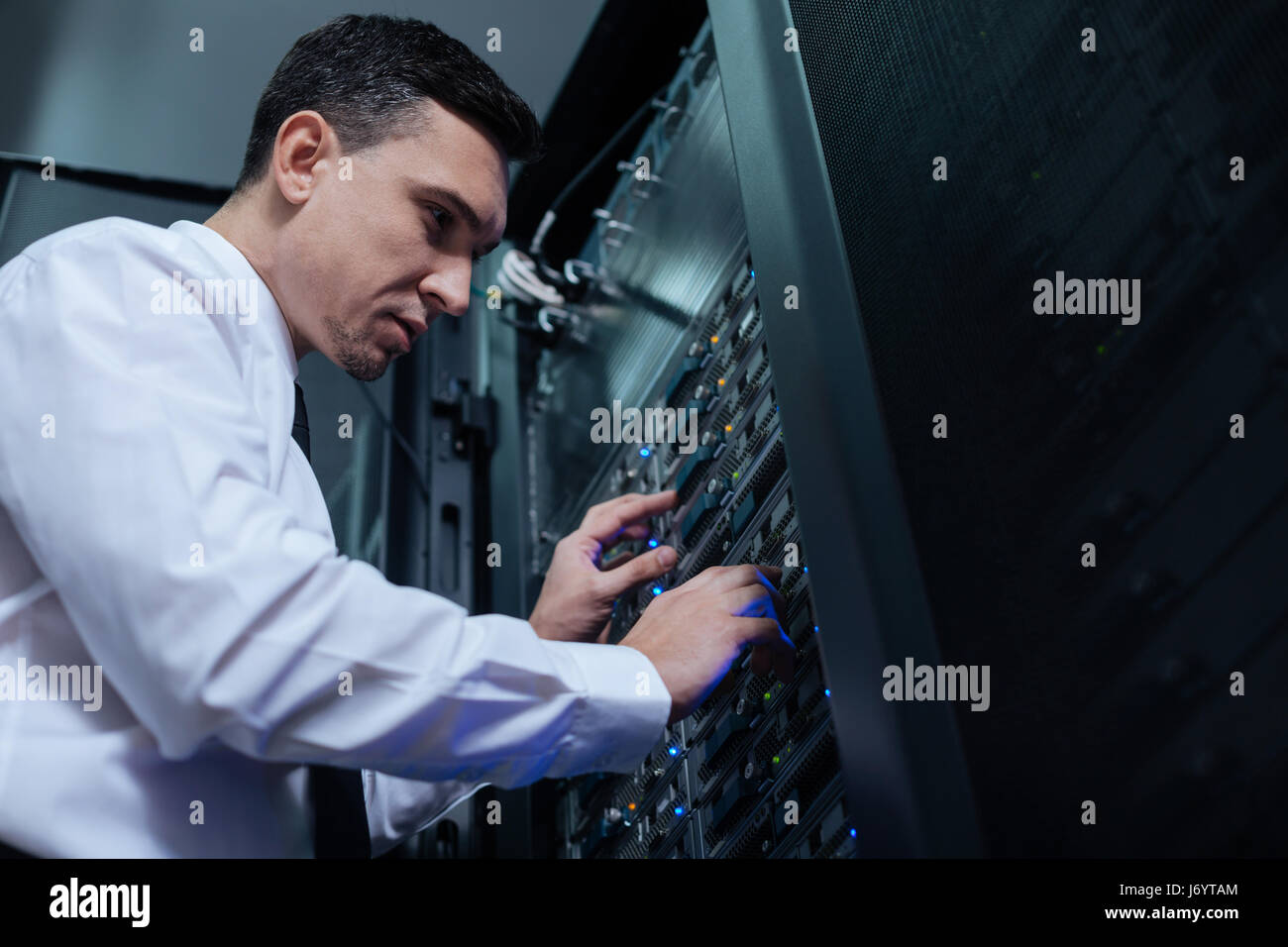 Professional computer engineer looking at the data server Stock Photo