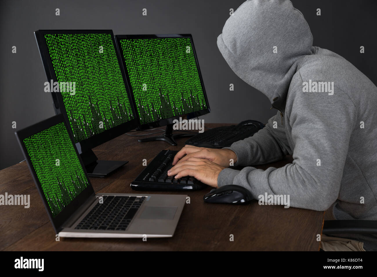 Hacker Typing On Computers With Binary Code At Desk Stock Photo Alamy
