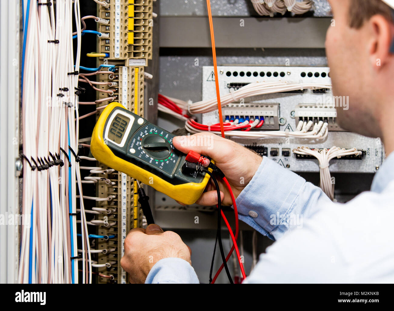 Engineer checking power supply with multimeter. Zero value of voltage