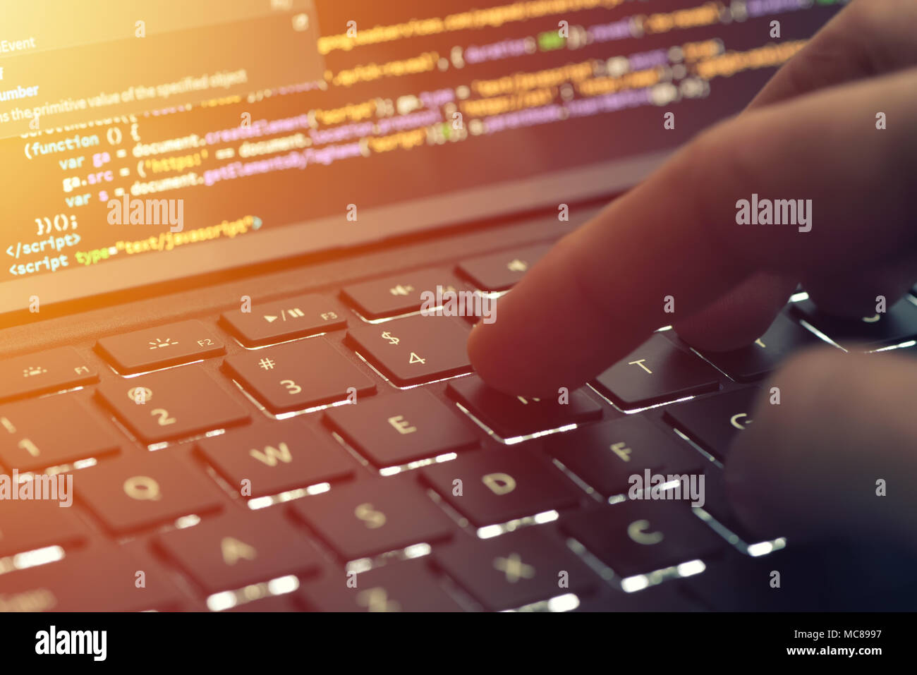 Closeup programmer coding on screen. Hands coding html and programming