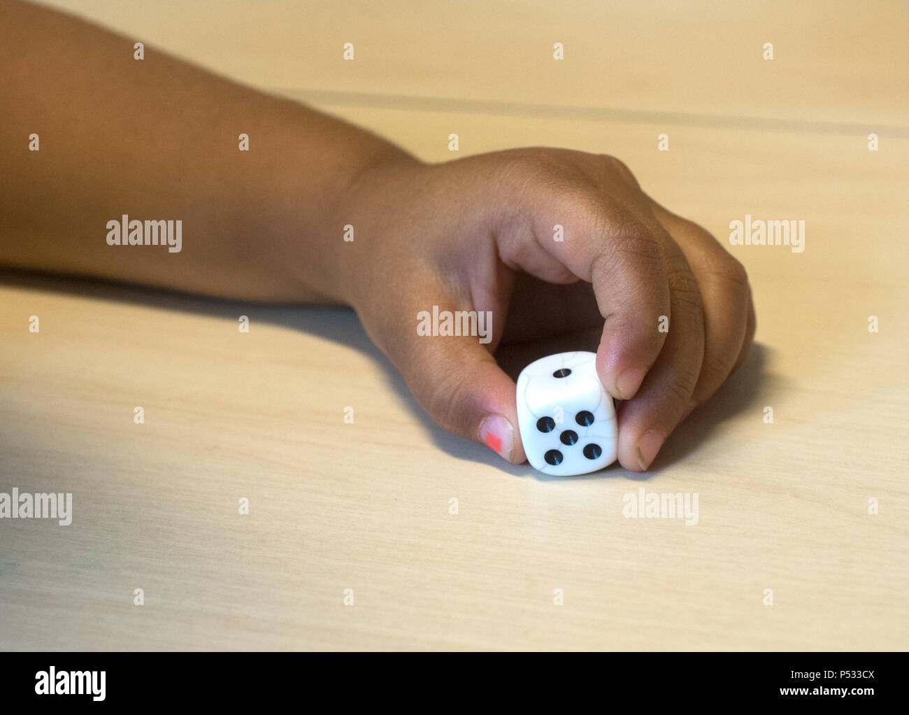 Children playing with a dice Stock Photo Alamy