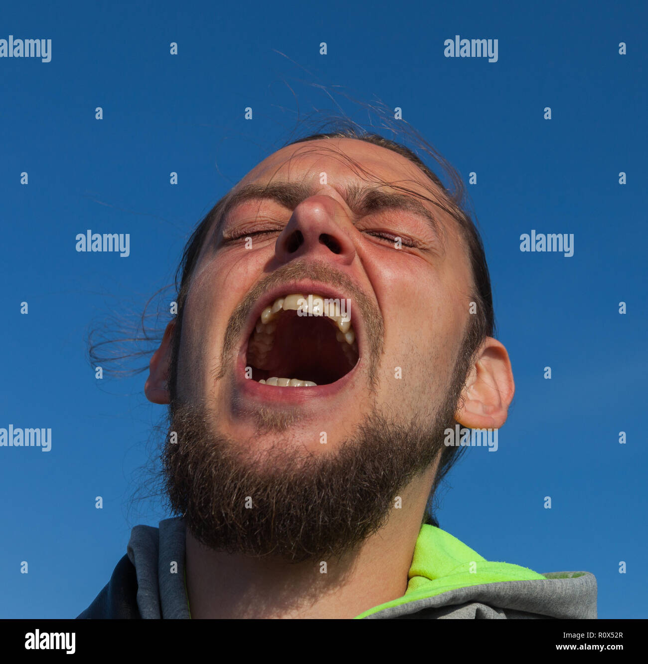 Young man is screaming help Stock Photo Alamy