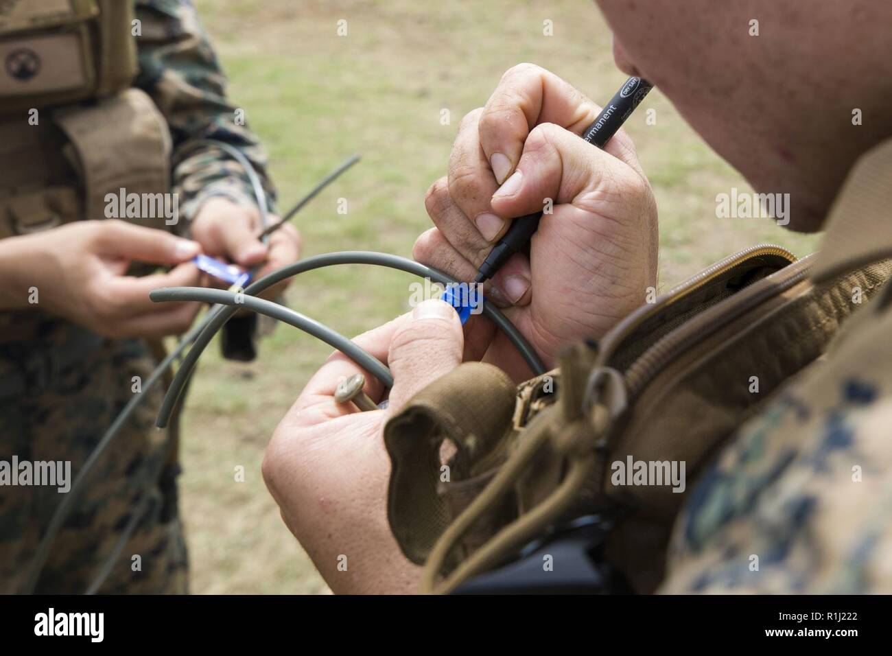 A U.S. Marine prepares detonation cord during a demolition and