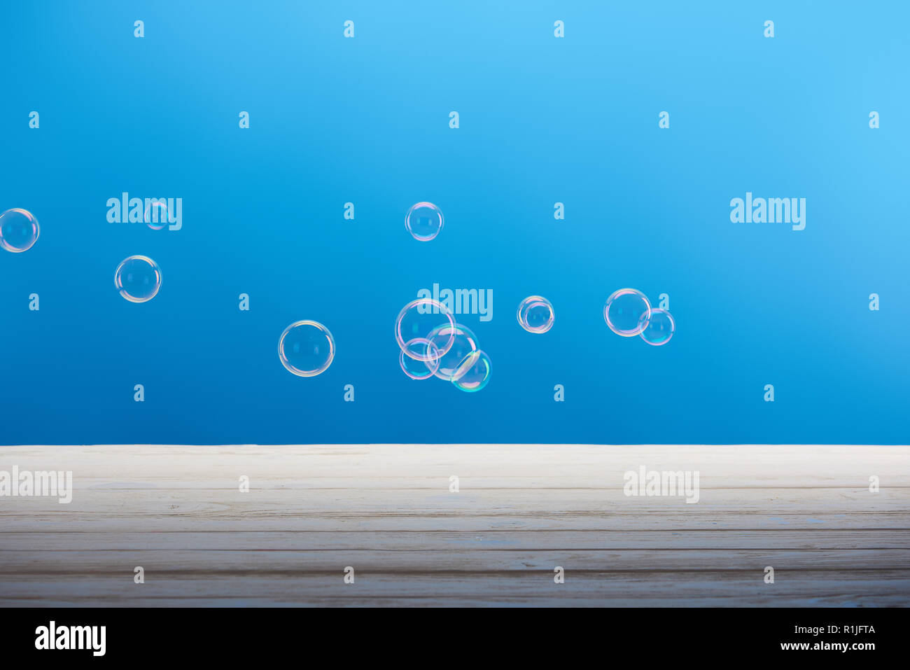 clean laundry soap bubbles on blue background Stock Photo Alamy