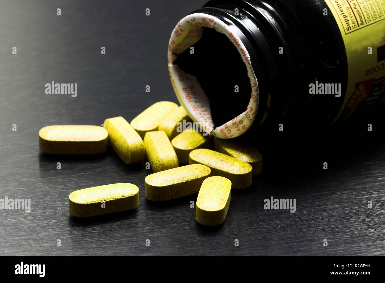 yellow pills on black Stock Photo Alamy