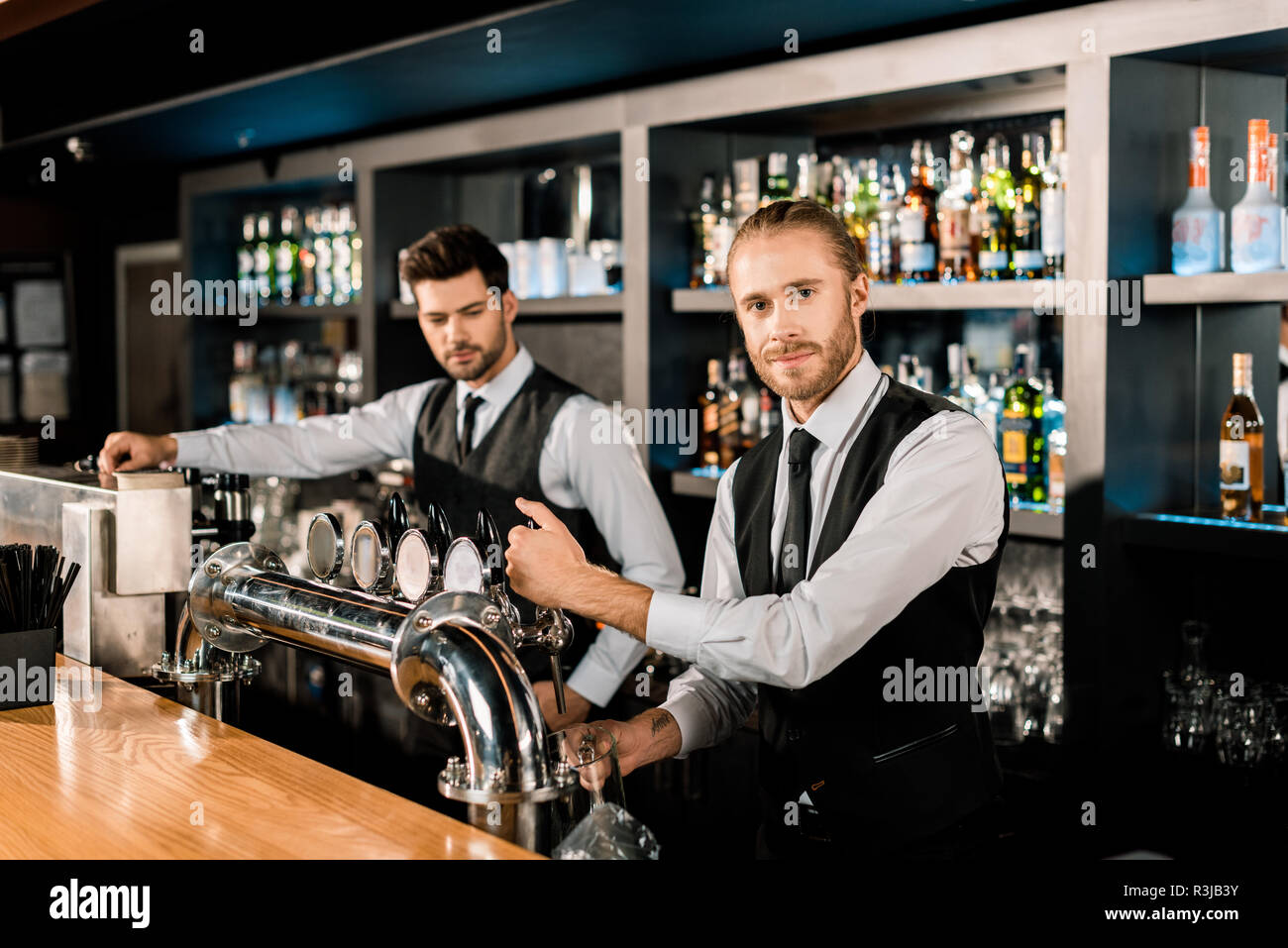 Handsome male bartenders working in bar Stock Photo Alamy