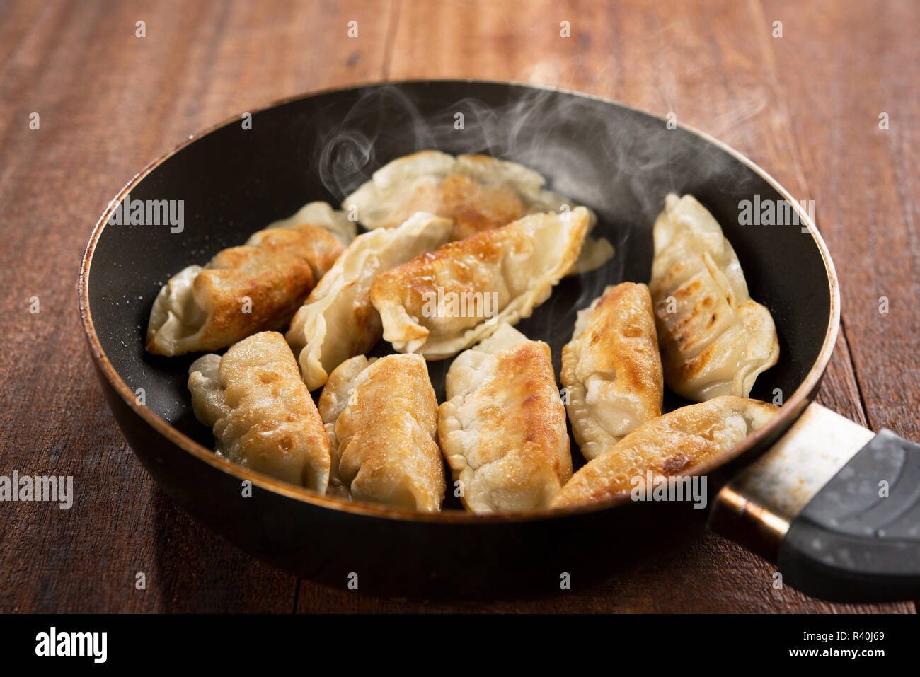 Fried dumpling in cooking pan Stock Photo Alamy