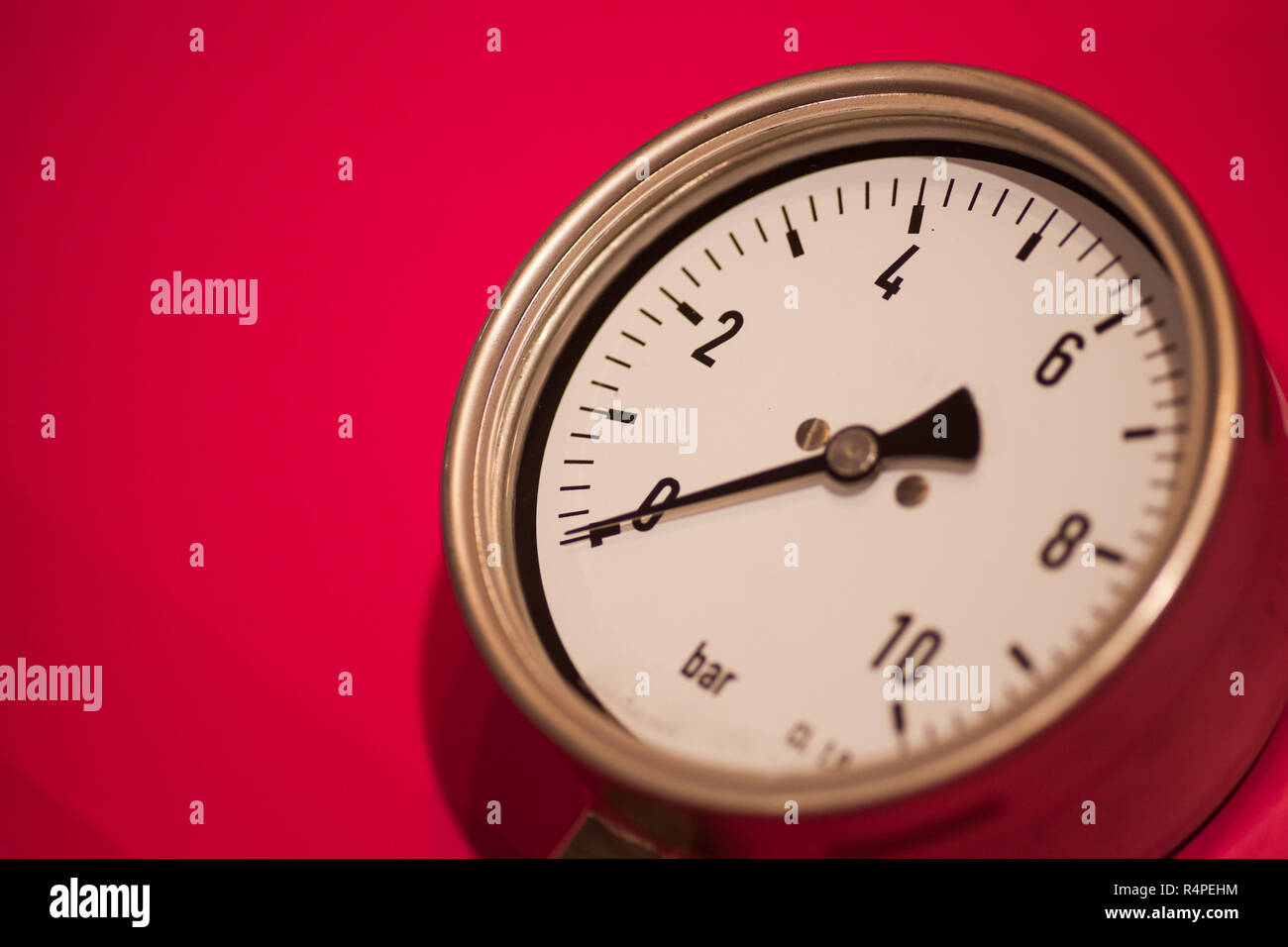 Pressure gauge on red background Stock Photo Alamy