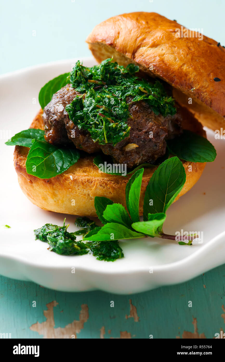 LAMB BURGERS WITH MINT SAUCE.style rustic .selective focus Stock Photo