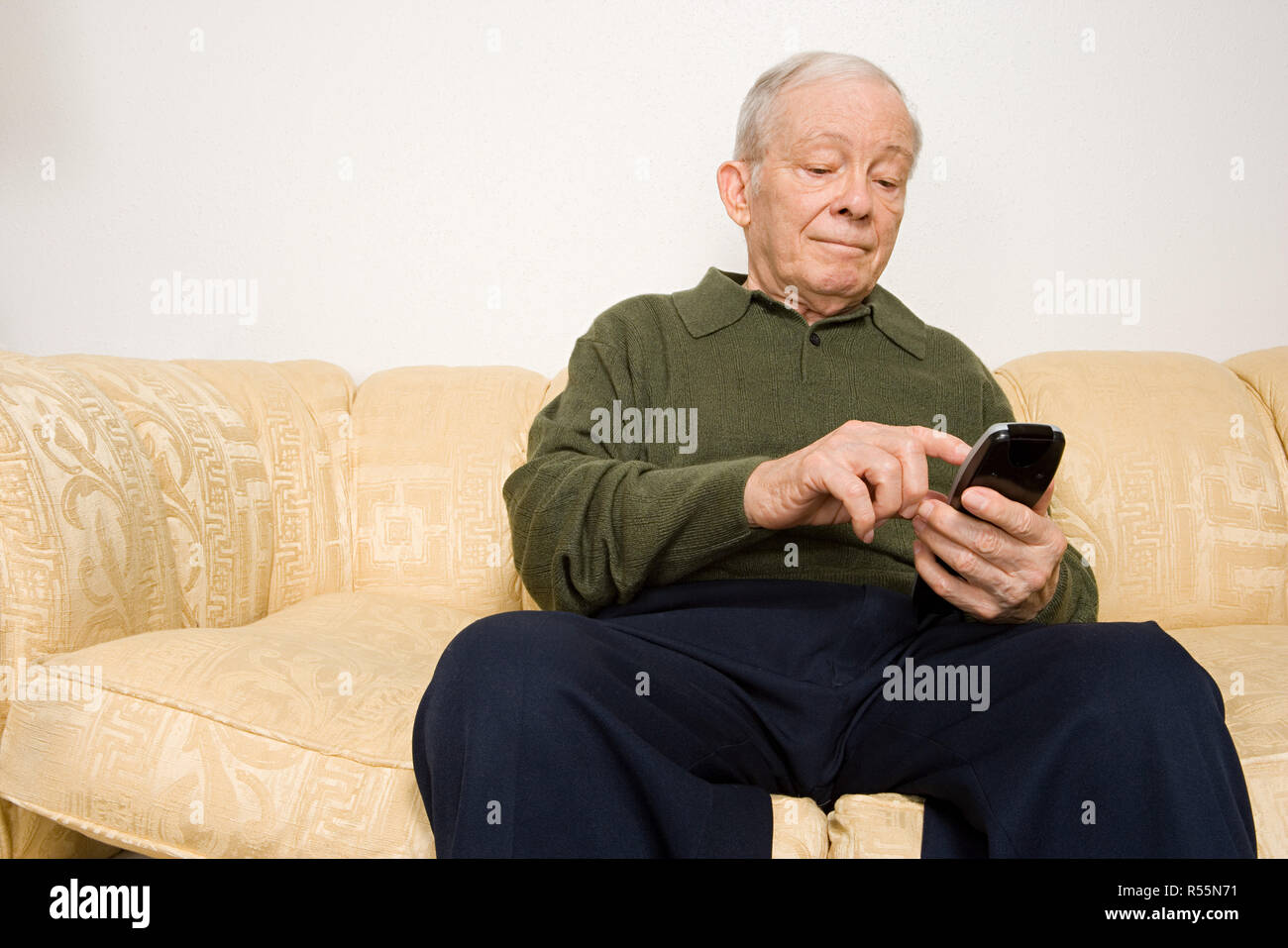 Elderly man using remote control Stock Photo - Alamy